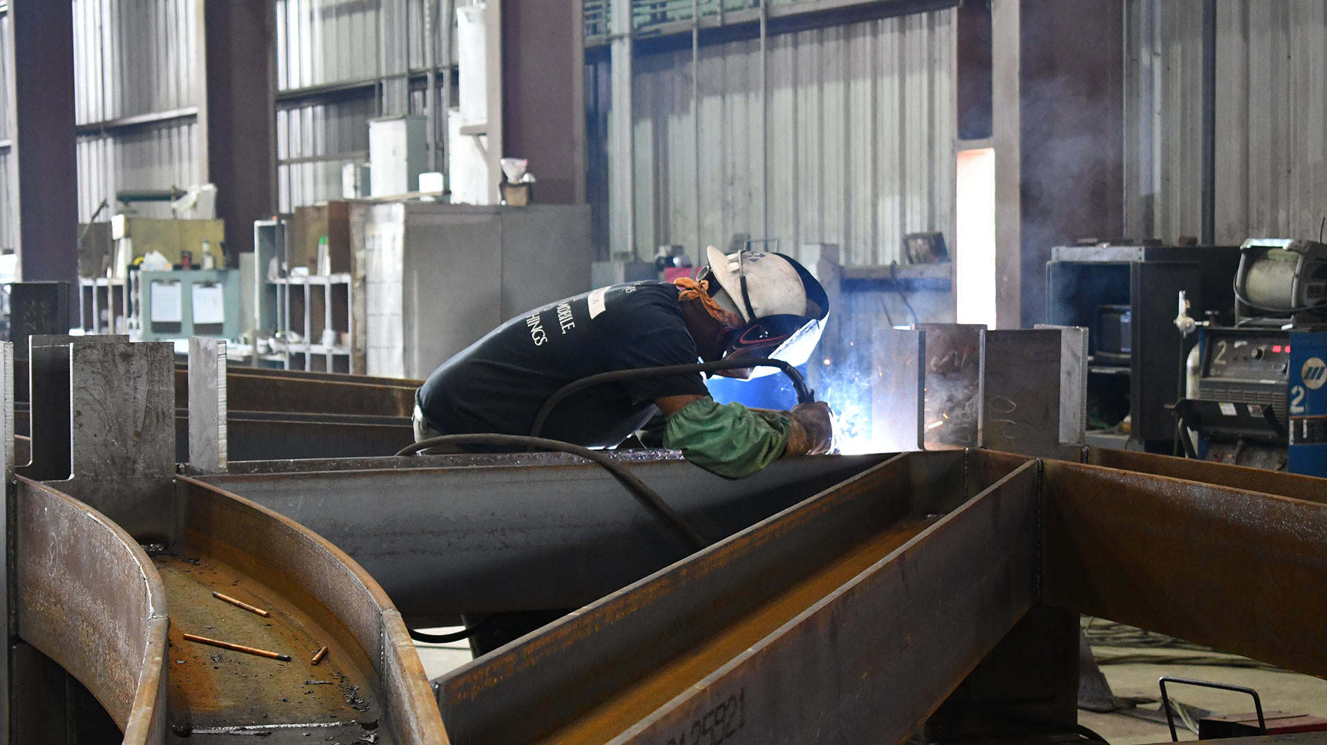 Man welding in a steel shop.