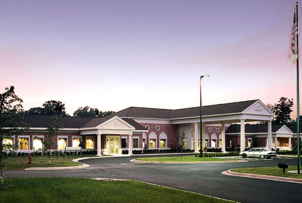 Exterior photo of Healthpark Hospital entrance at dusk.