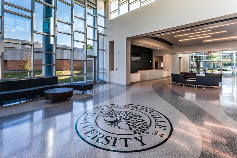 Frisch Welcome Center lobby featuring Jacksonville University logo inset in terrazzo floor