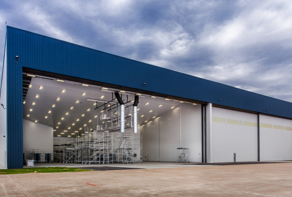 Exterior of MAAS Aviation Painting Facility. Hangar door open showing inside of painting facility.
