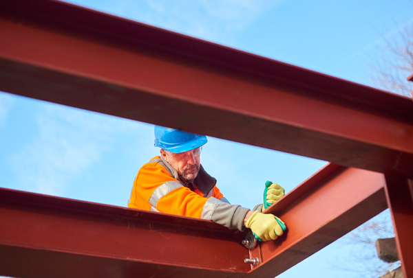 Construction worker assembling steel beams