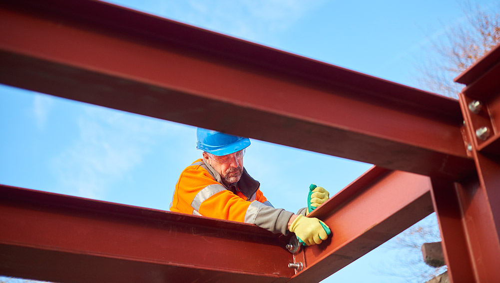 Construction worker assembling steel beams