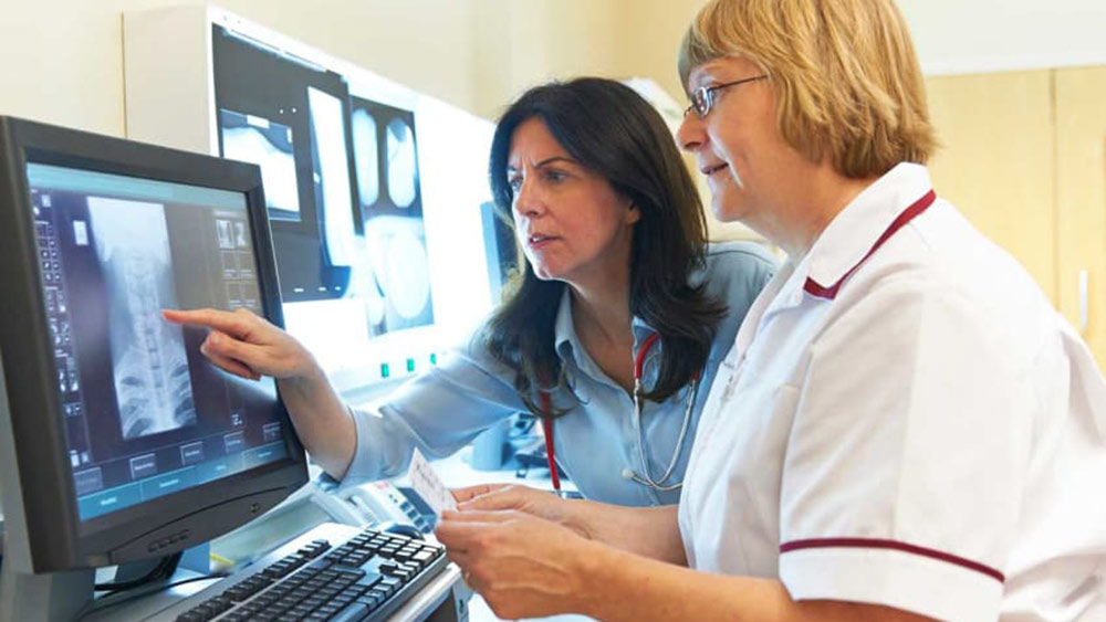 Two women looking at an x-ray.