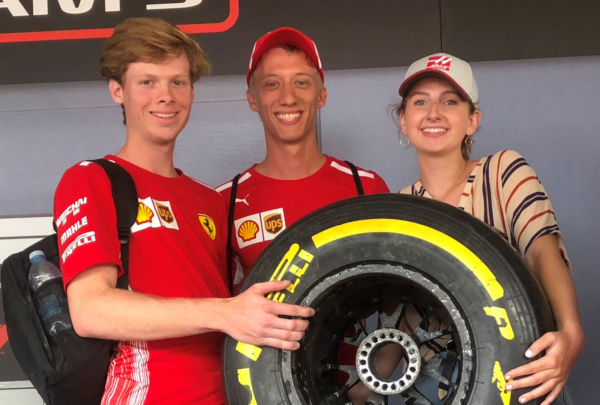 Haskell intern Emily Moseley holding a racing tire.