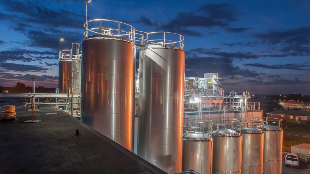 Dairy storage tanks at dusk.