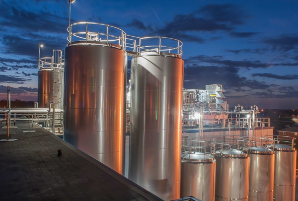 Dairy storage tanks at dusk.