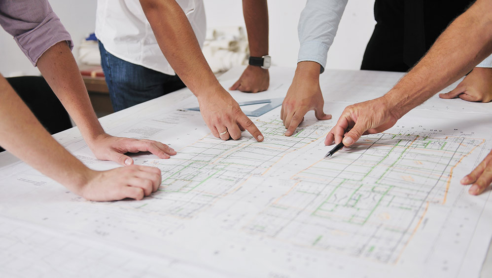 Team working on architectural drawings.