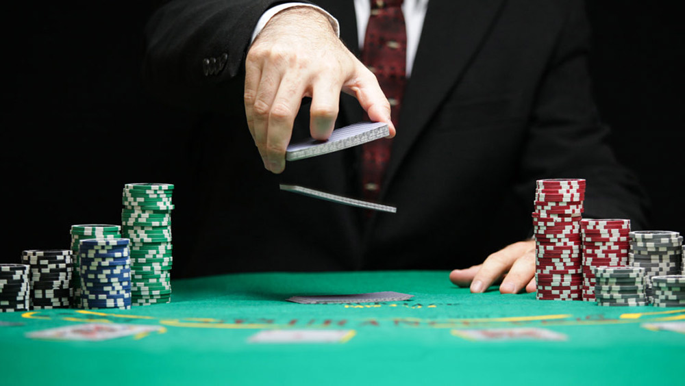 Man shuffling cards at poker table
