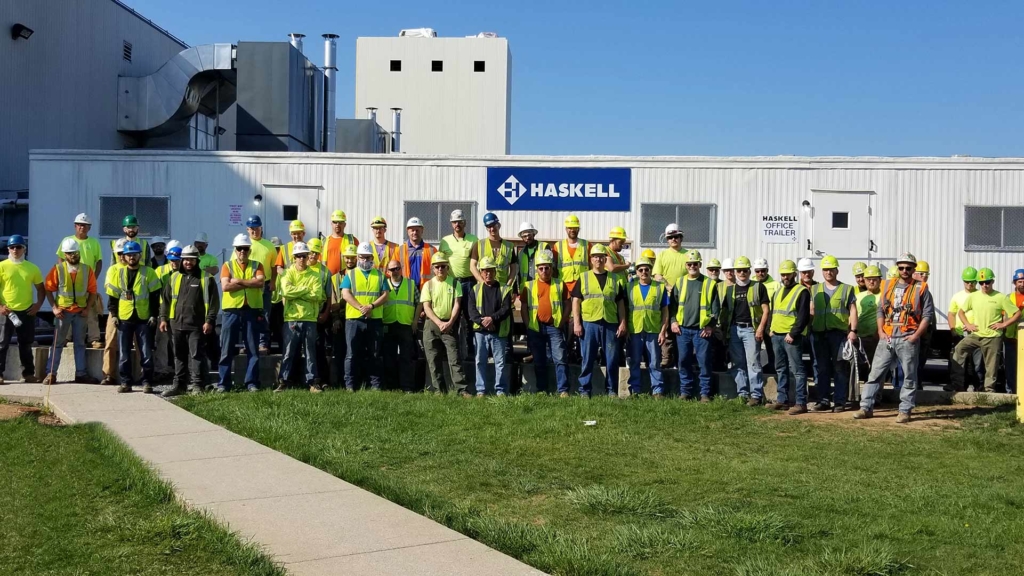 Haskell team members standing near jobsite trailer.