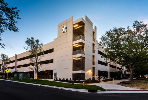 Exterior photo of Baptist parking structure's main corner mid-day.