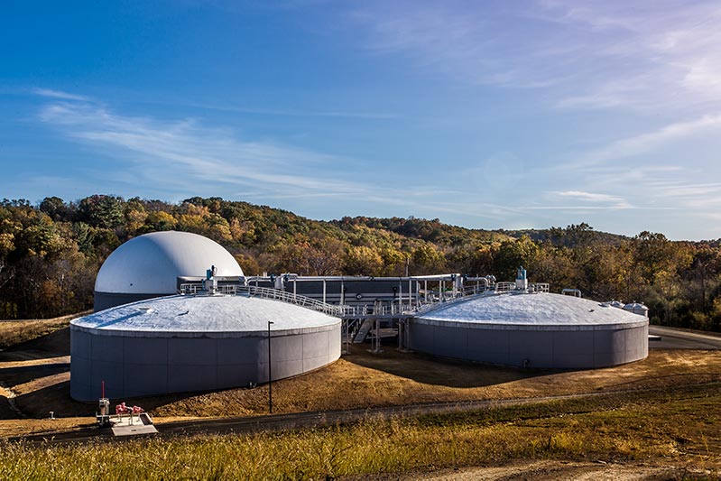 Domed grey and white wastewater processing tanks