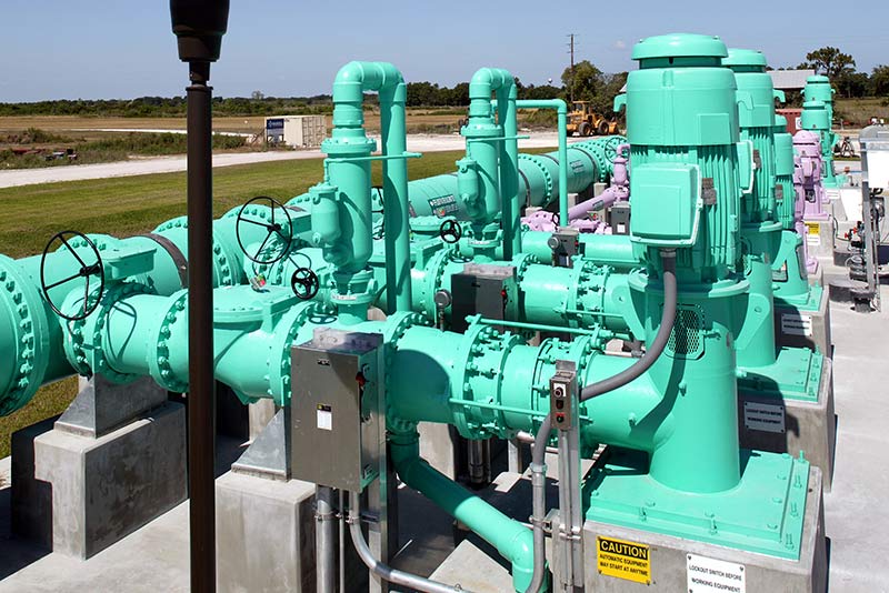 Green pipes and motors outside the facility