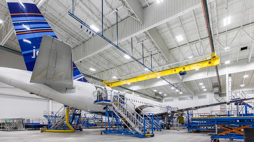 Airplane sitting inside Lufthansa Technik Heavy Maintenance Facility.