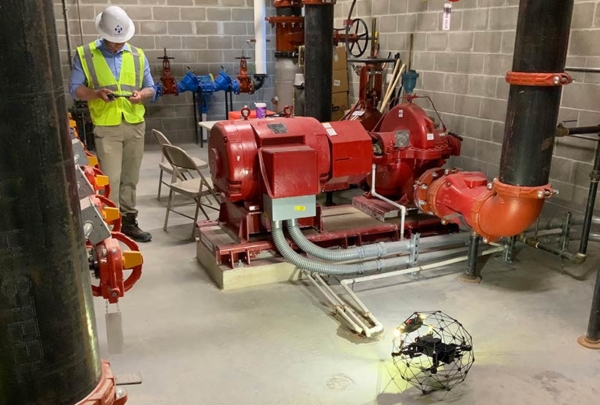 Person operating drone on construction site.