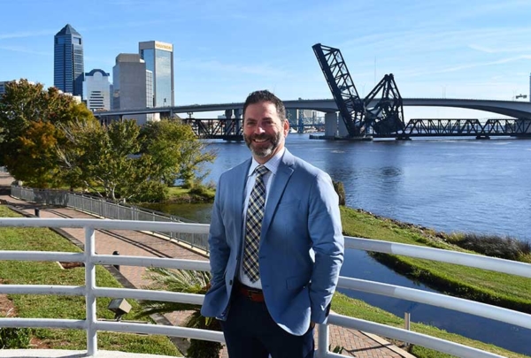 Allan Iosue in front of Jacksonville skyline.