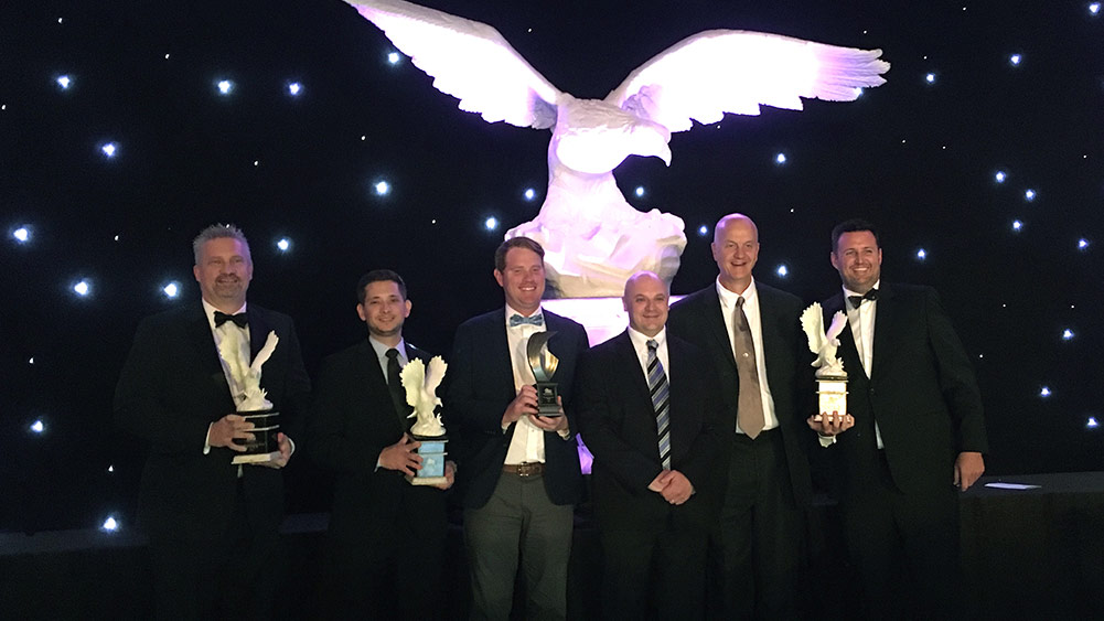 Haskell team members pose with awards.