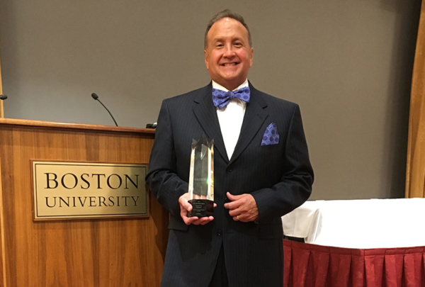 David Thaeler posing with award at Boston University
