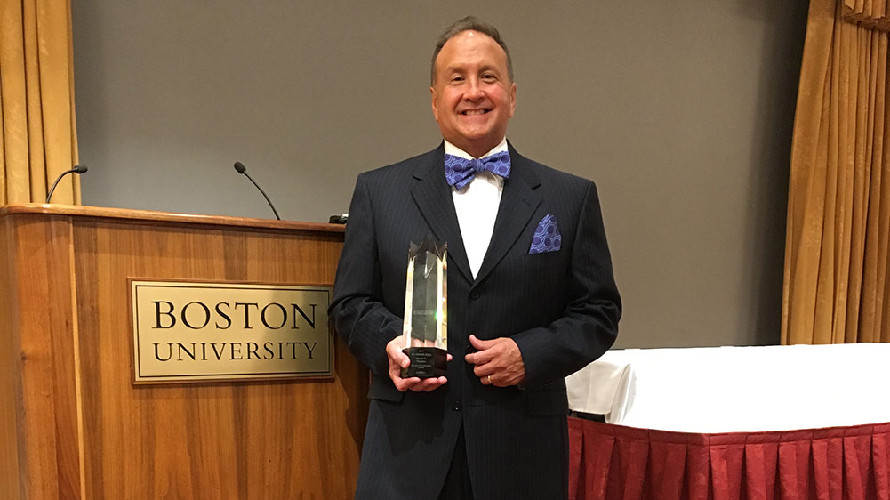 David Thaeler posing with award at Boston University