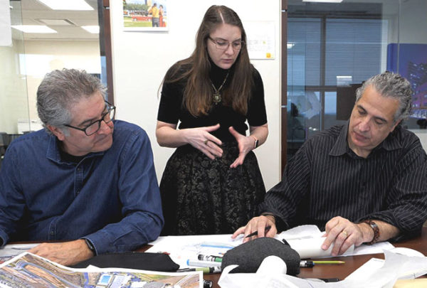 Three individuals collaborate during a design charrette