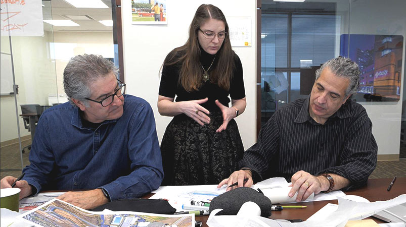 Three individuals collaborate during a design charrette