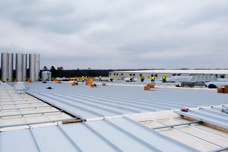 With Haskell’s innovative “roof-on-roof” solution, teams could complete the reroofing effort using a series of clamps rather than screws. This was critical because screws could expose the manufacturing area underneath to contaminants such as metal shavings, air, and water.