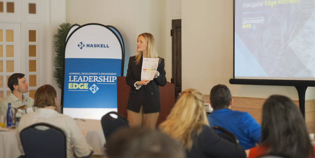 Corporate Trainer Liz Powell addresses the 30 Haskell team members assembled for the Edge Retreat.