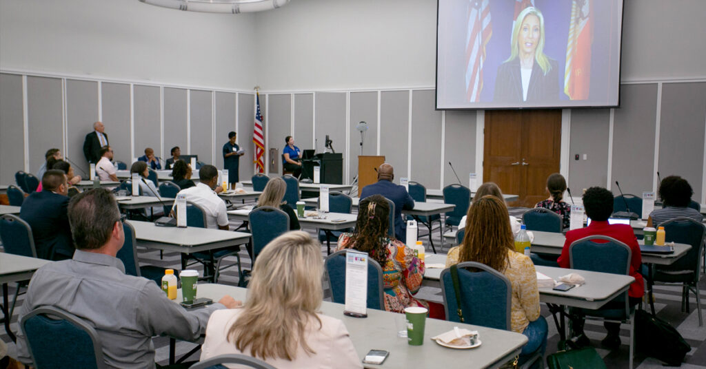 Participants in the task force working on the Creating Safe Spaces and Vision Zero Action Plans listen as Jacksonville Mayor Donna Deegan addresses their meeting.