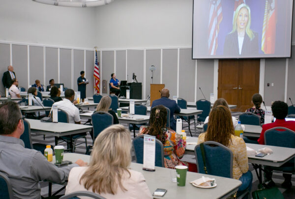 Participants in the task force working on the Creating Safe Spaces and Vision Zero Action Plans listen as Jacksonville Mayor Donna Deegan addresses their meeting.