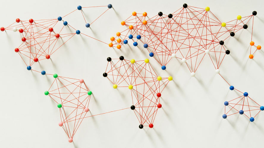 World map made of push pins and string.|