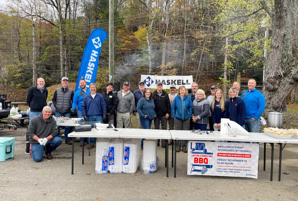 Team members from Haskell’s Charlotte office prepare to serve barbecue meals to residents and recovery workers in Lake Lure