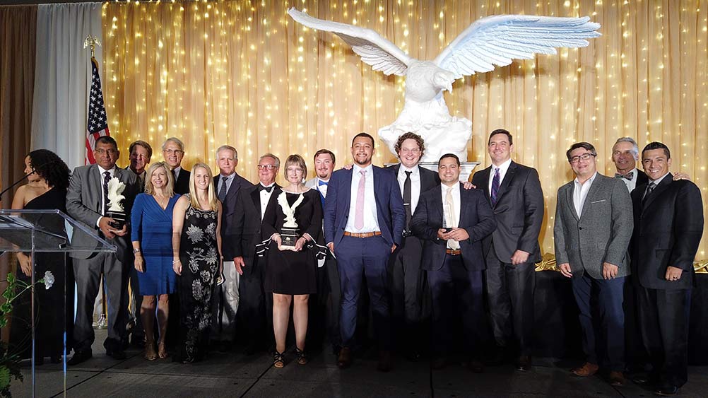 Haskell project team posing with award.|