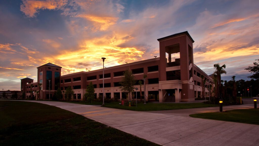 Sunset photo of UCF Parking Garage|Interior of UCF Parking Garage|Exterior of UCF Parking Garage|Stormwater retention basin adjacent to parking garage|Twilight photo of UCF Parking Garage|Education Garage Blue Background||||||