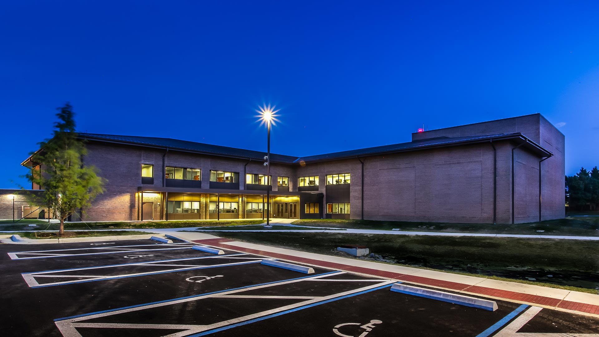 Nighttime photo of Andrews HOF|Nighttime photo of Andrews HOF|Andrews HOF exterior|Andrews HOF exterior|Andrews HOF interior|Bicycle racks and walkways at HOF entrance|Seating area with squadron emblems|Andrews HOF interior|Secure access point|Operational support offices||||||||||