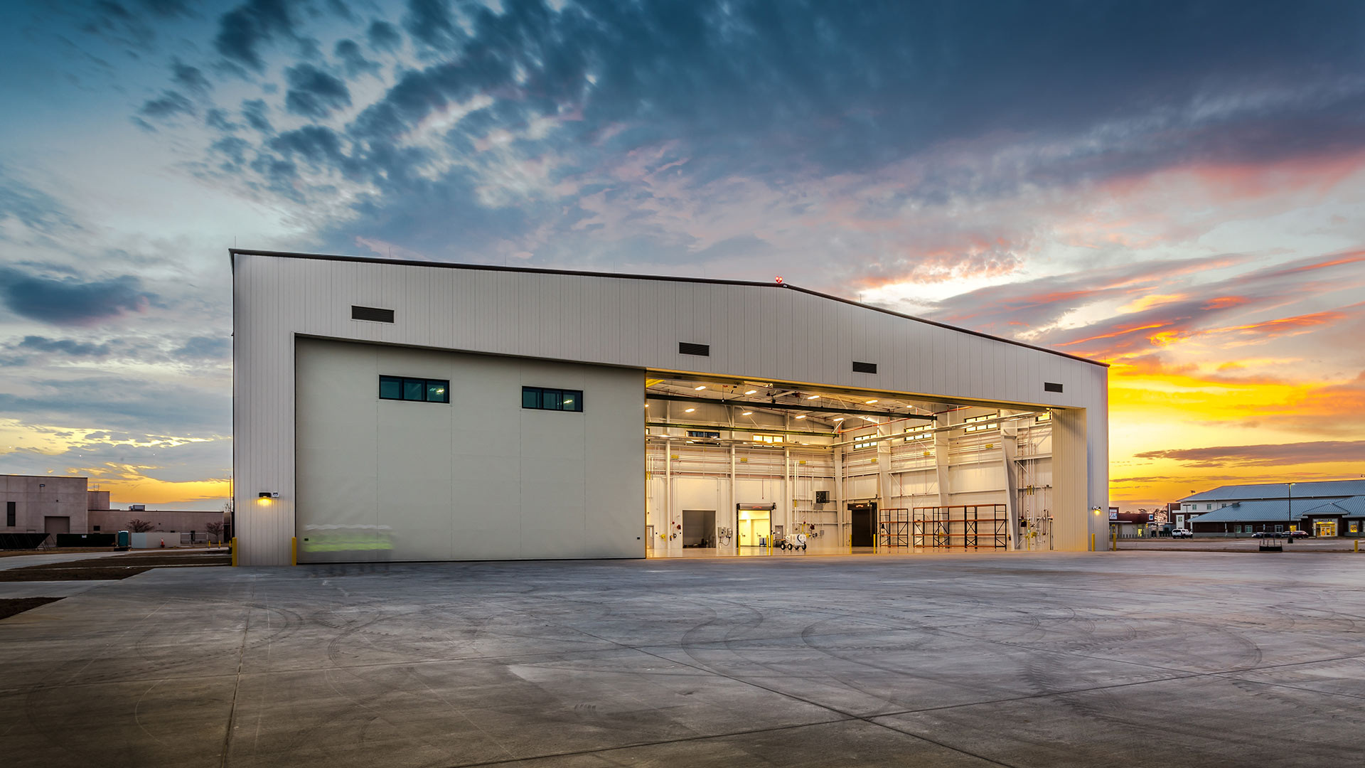 Sunset photo of Elizabeth City MTU building|Elizabeth City MTU interior with mock-up training aircraft fuselage|Elizabeth City MTU interior|Sunset photo of Elizabeth City MTU building|Elizabeth City MTU building exterior|Sunset photo of Elizabeth City MTU building||||||