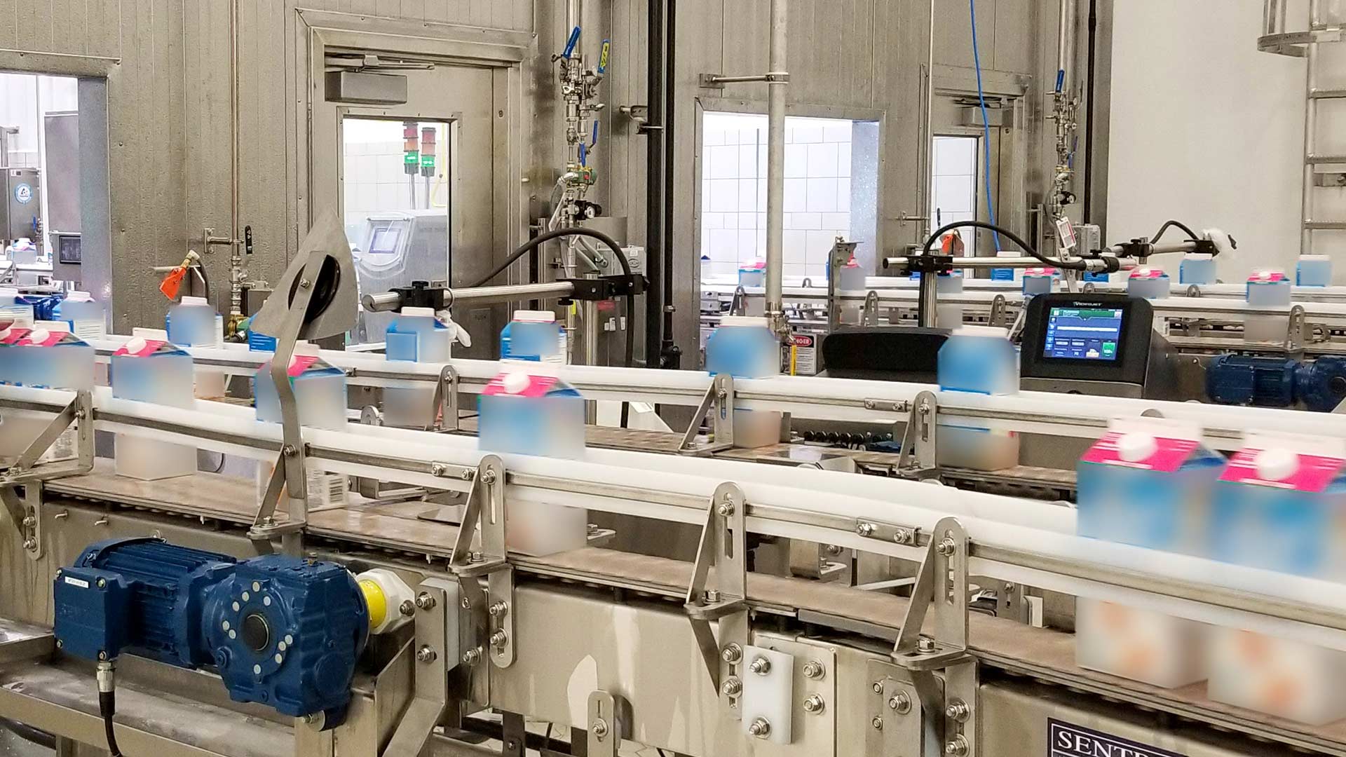 Hood Dairy packaging line|Hood Dairy packaging line in operation|Construction photo of Hood Dairy Facility|Hood Dairy packaging line in operation|Construction crane placing stainless steel vessels at Hood Dairy Facility.|Hood Dairy Processing Facility warehouse area|Hood Dairy packaging line with product cartons|||||||