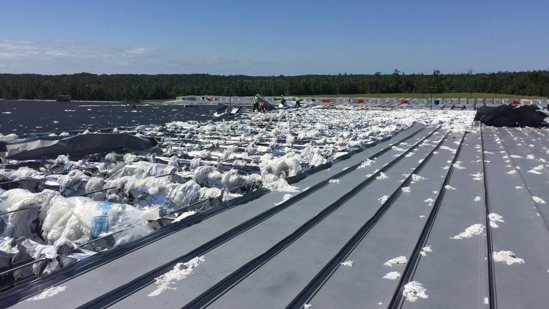 Storm damage to Nestle Waters facility|Storm damage to Nestle Waters facility|Bottled water packaging line in operation|Nestle Waters facility roof damage|Wrapped