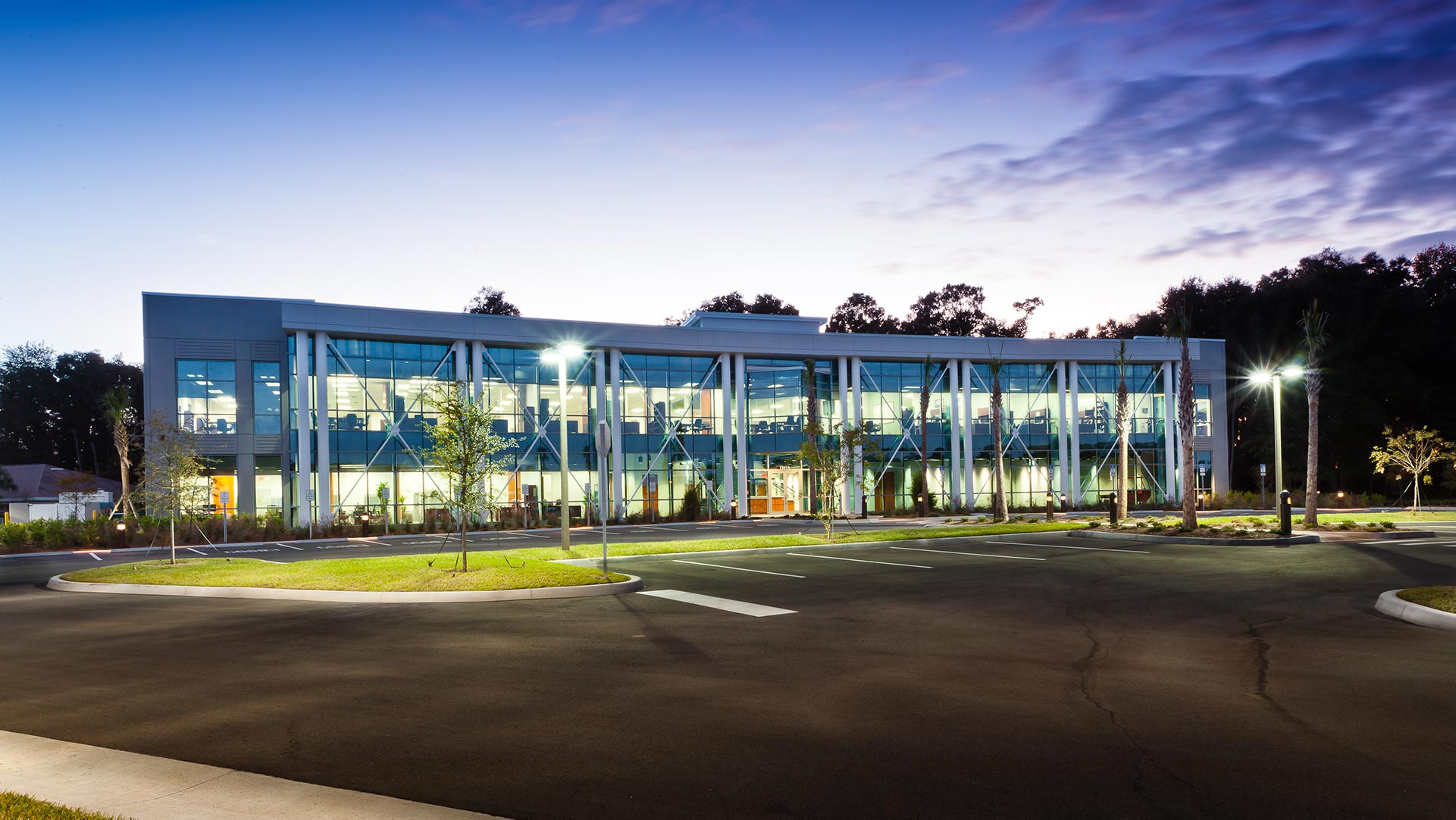 Exterior of NCCER Headquarters Building|Wood paneled reception desk in front of bifurcated blue stairway|Exterior of NCCER Headquarters Building|Meeting Room||||