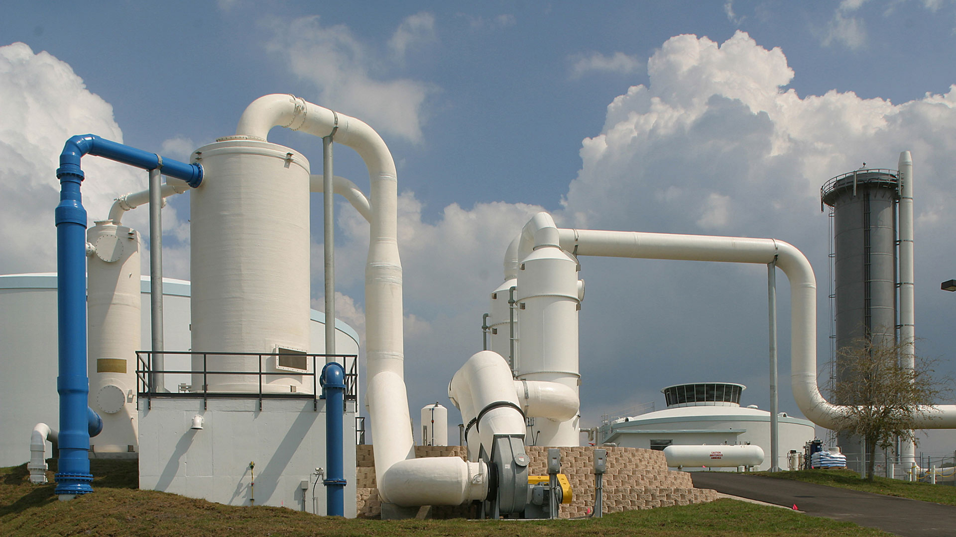 Large white storage tanks and piping outside the SMRU Water Treatment Facility|Aerial view of the SMRU Water Treatment Facility|Large pipes inside the facility at the SMRU Water Treatment Facility|Membrane filtration system inside the facility at the SMRU Water Treatment Facility|Large white storage tanks and piping outside the SMRU Water Treatment Facility|||||