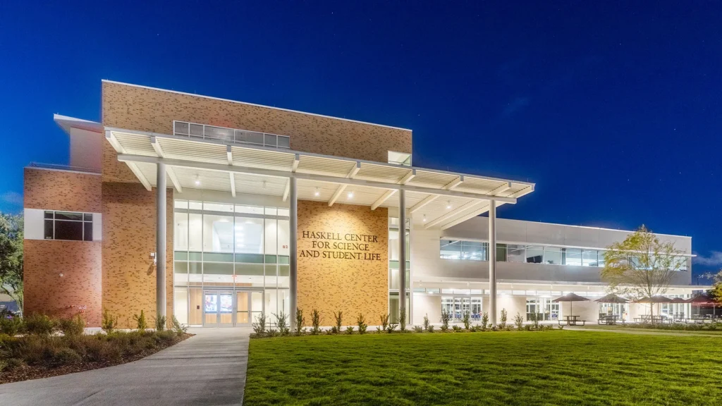 Illuminated entrance to the Haskell Center for Science and Student Life at night.