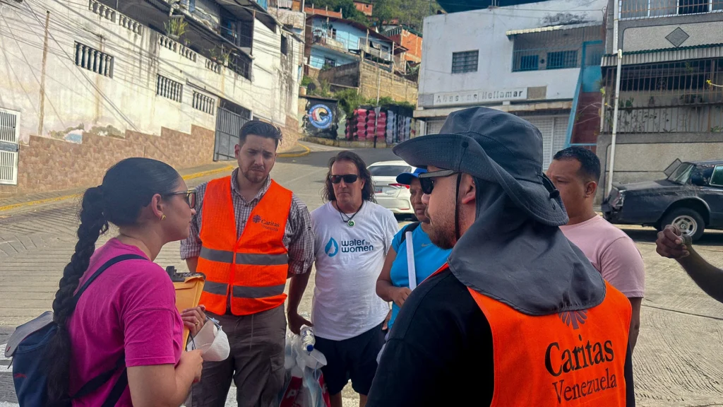 From left, Luisana Fernandez, Manuel Fernandez and Shawn Huffman meet with Cáritas team members in La Guaira, Venezuela.