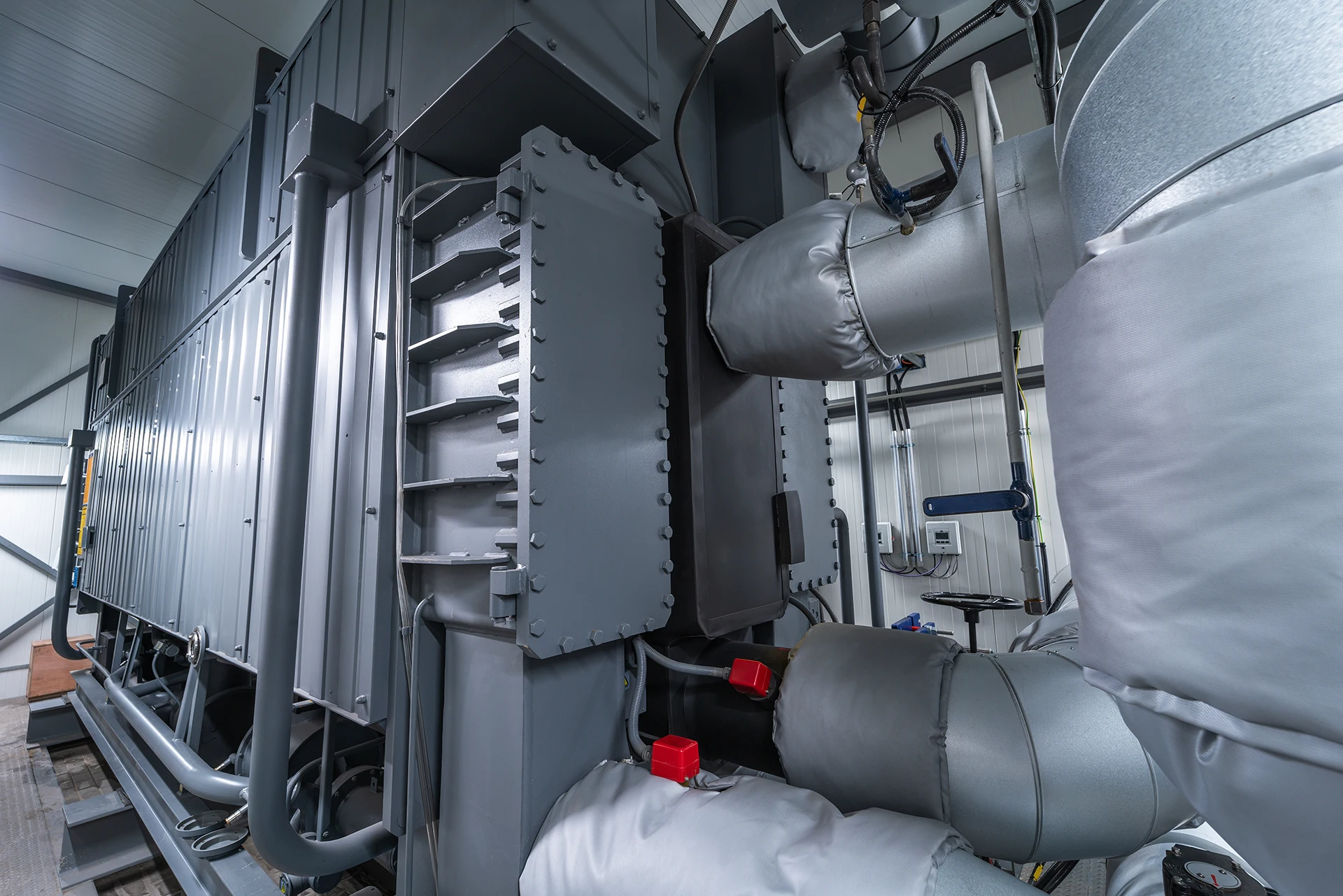 An industrial absorption heat pump helps recover and reuse thermal energy within a power plant. 