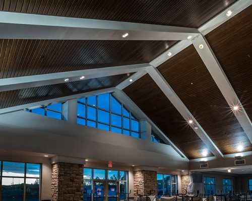 Dining Facility interior featuring dark wood ceiling with white rafters