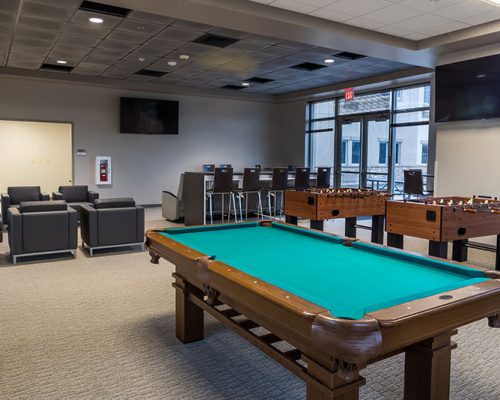 Recreation Area with game tables, lounge chairs and video screens