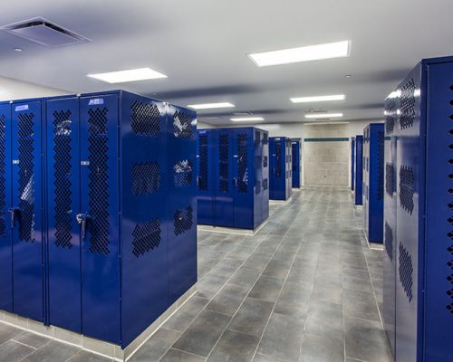Locker Room with bright blue lockers and grey tile surfaces