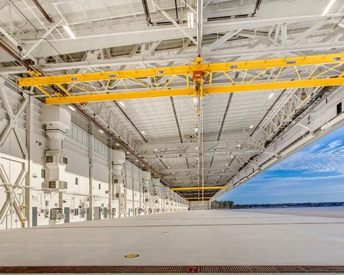 All-white interior of MV-22 Hangar brightly lit with natural and fluorescent light