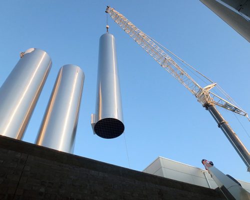 Construction crane placing stainless steel vessels at Hood Dairy Facility.