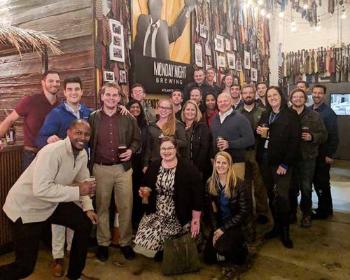 Haskell Atlanta employees pose for an on-boarding dinner photo