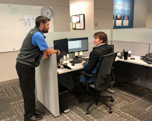 Two Haskell employees talking in the Dallas office