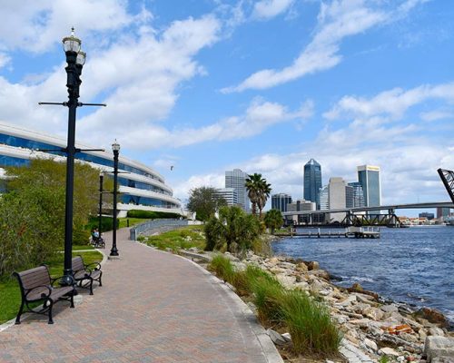 Exterior photo of Jacksonville office along the river. City skyline is in the back ground.