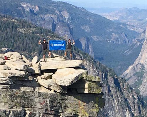 Livermore office employees hoist a Haskell flag atop Half Dome